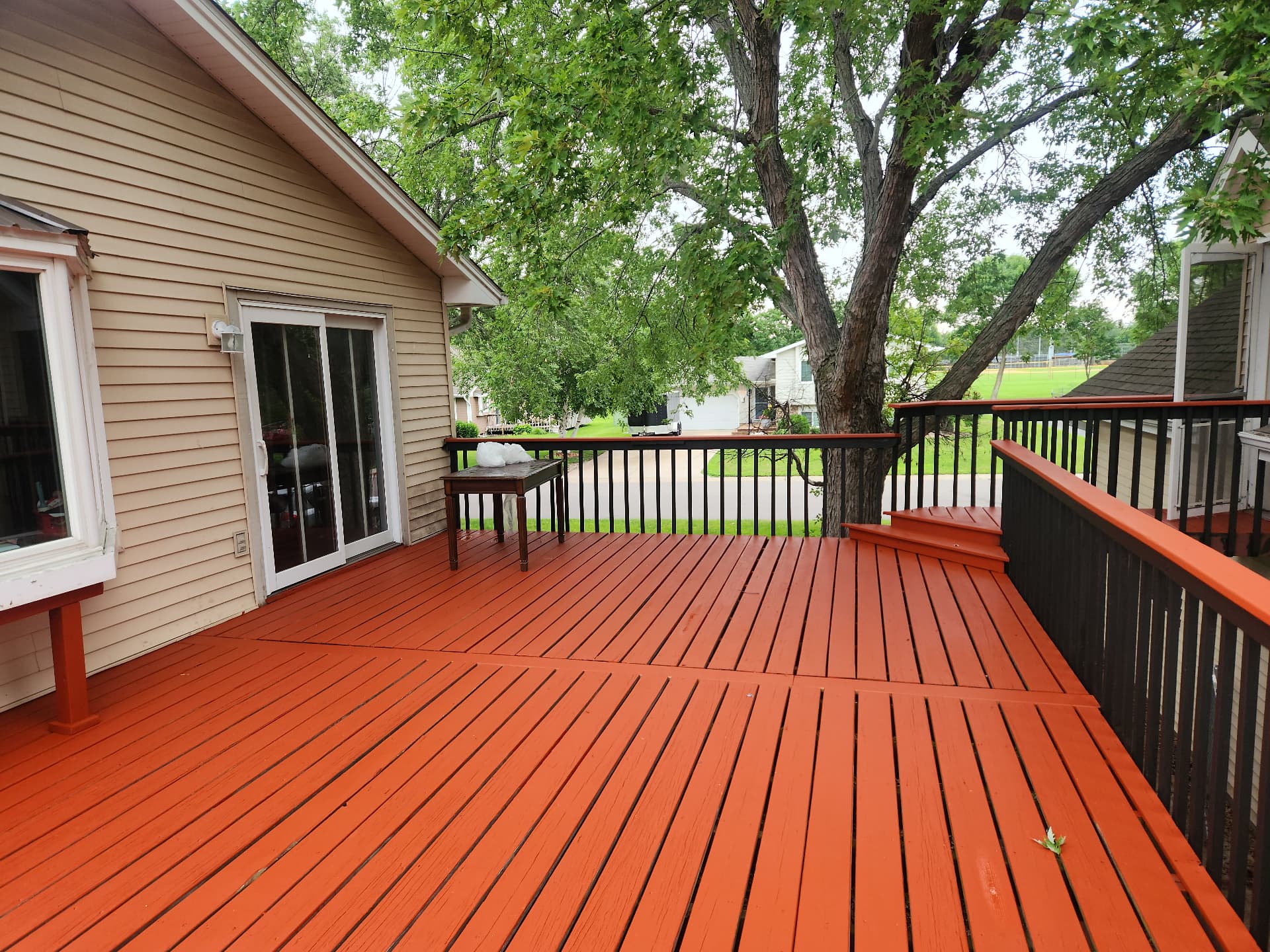 Freshly refinished exterior deck with new railing and stain